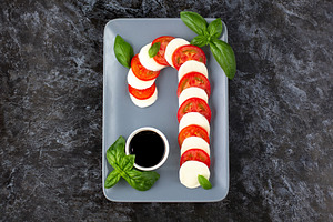 Caprese salad in form of candy cane featuring christmas, salad, and candy