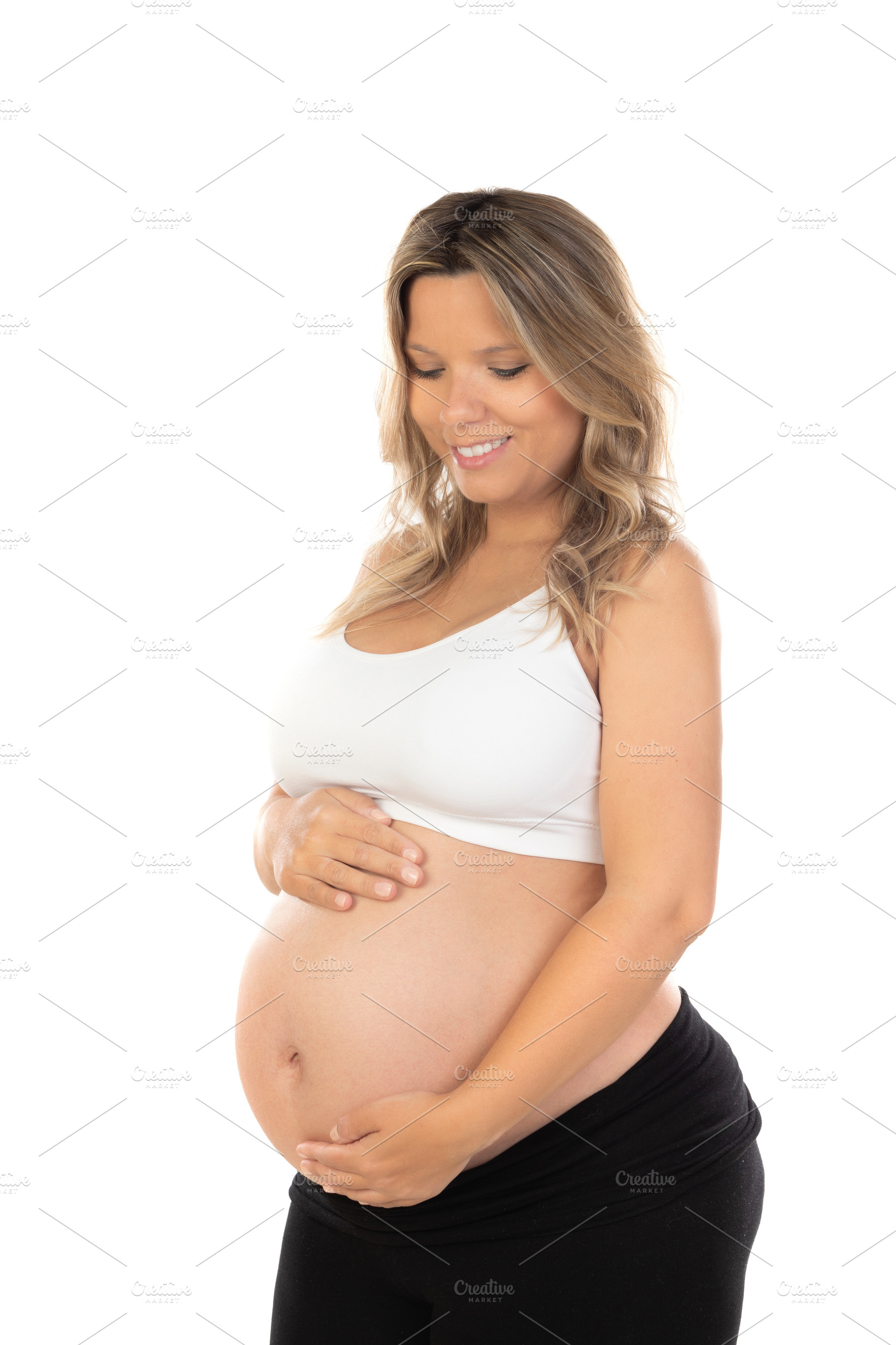 Young beautiful blonde woman pregnant expecting baby over isolat, a Person Photo by José Manuel Gelpi