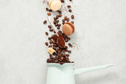 Coffee turk and flying coffee beans and macarons on concrete bac, a Food & Drink Photo by Natalia Klenova's Shop