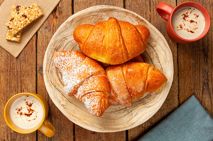 Delicious freshly baked croissants and cappuccino enjoying breakfast, a Food & Drink Photo by Antonio Gravante Market