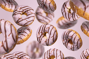 Levitating donuts with pink icing on a bright pink background, a Food & Drink Photo by ndanko