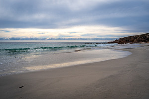 Stokes Bay Beach at sunset with waves and rocks, Australia