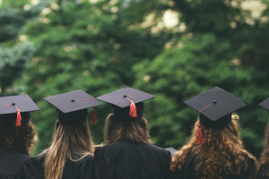 Group of graduated students featuring graduate, looking, and student, a Person Photo by Koldunov