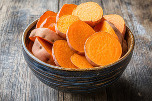 Sweet potatoes in rustic bowl, a Photo by Pavel_design