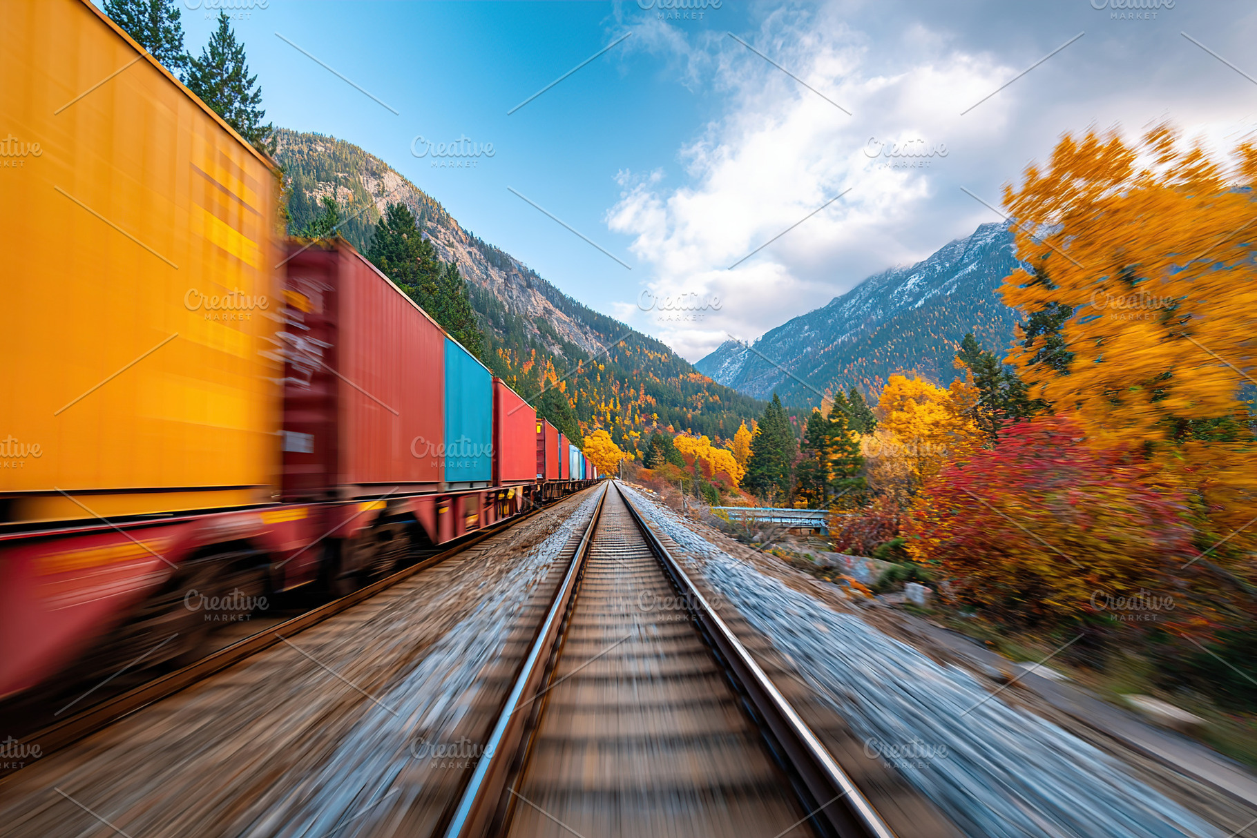 Container train moves through autumn landscape with colorful foliage and mounta, a Transportation Photo by AlyaAnd