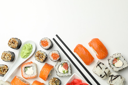 Delicious sushi rolls on white background, top view. Japanese fo, a Food & Drink Photo by AtlasStudio