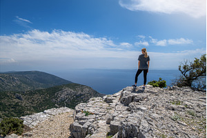 Young woman hiking on a cliff and, a Person Photo by den-belitsky