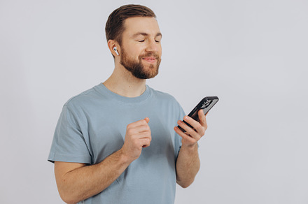 Happy bearded man dancing with earphones, listening music in hea, a Technology Photo by Cherkas Photography
