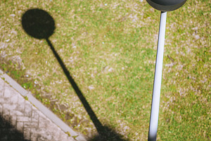 Streetlamp shadow on sunny grass, an Architecture Photo by SkyNext