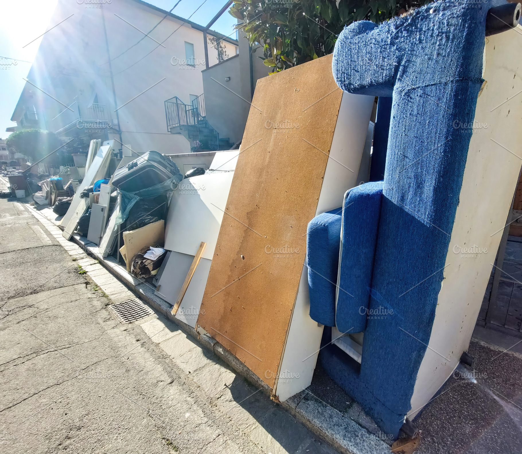 Pile of furniture and waste accumulating on suburban street after flood, an Architecture Photo by Antonio Gravante Market