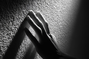Hand on textured wall black and whit, a Photo by Pixeness Studio