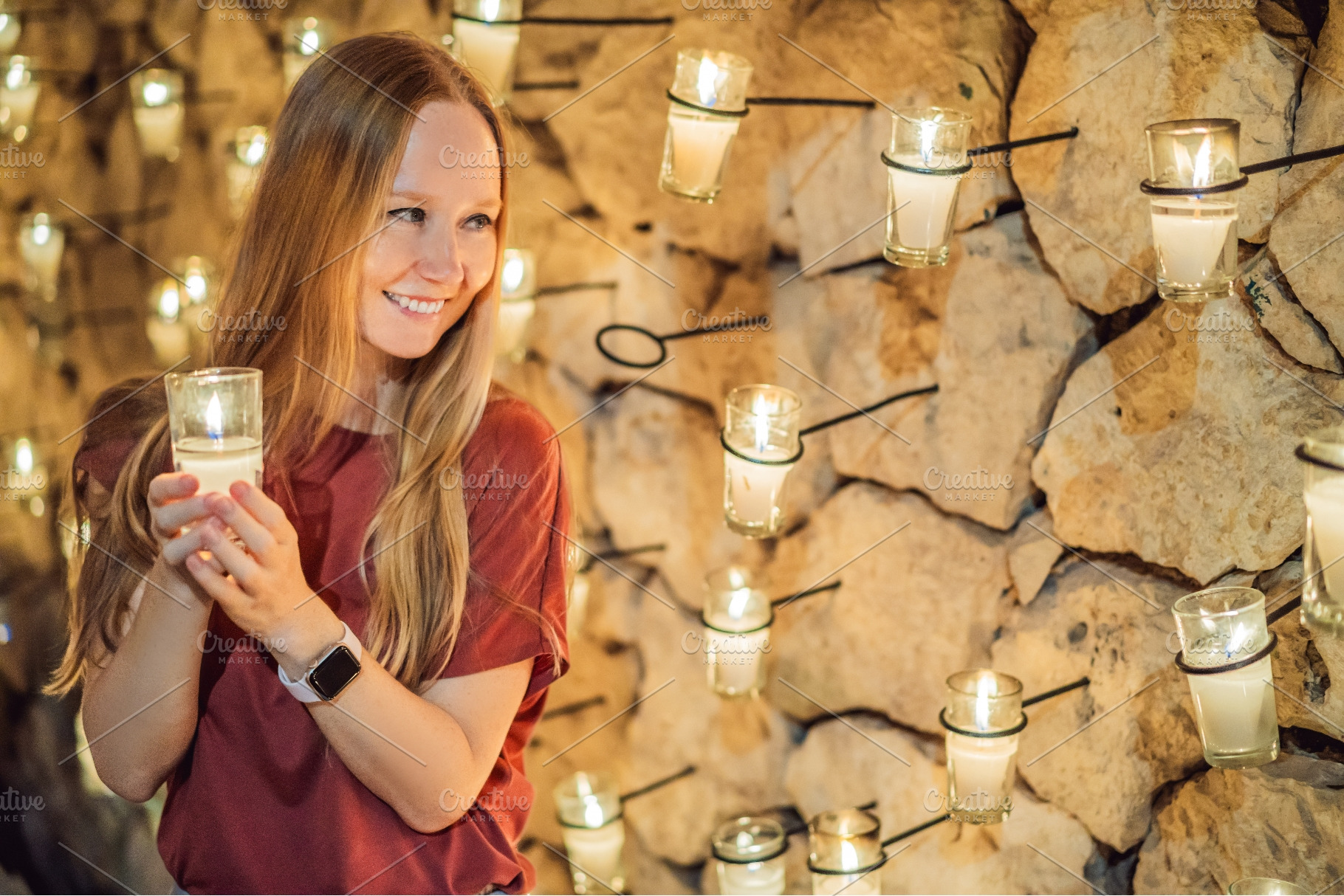 Visitor holding candlelight during a, a Person Photo by Elizaveta Galitskaya
