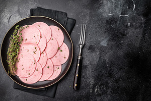 Sliced pink lunch meat (bologna/mortadella) with fresh thyme on, a Food & Drink Photo by composter-box@mail.ru