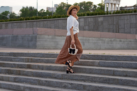 Fashionable woman walks up steps
