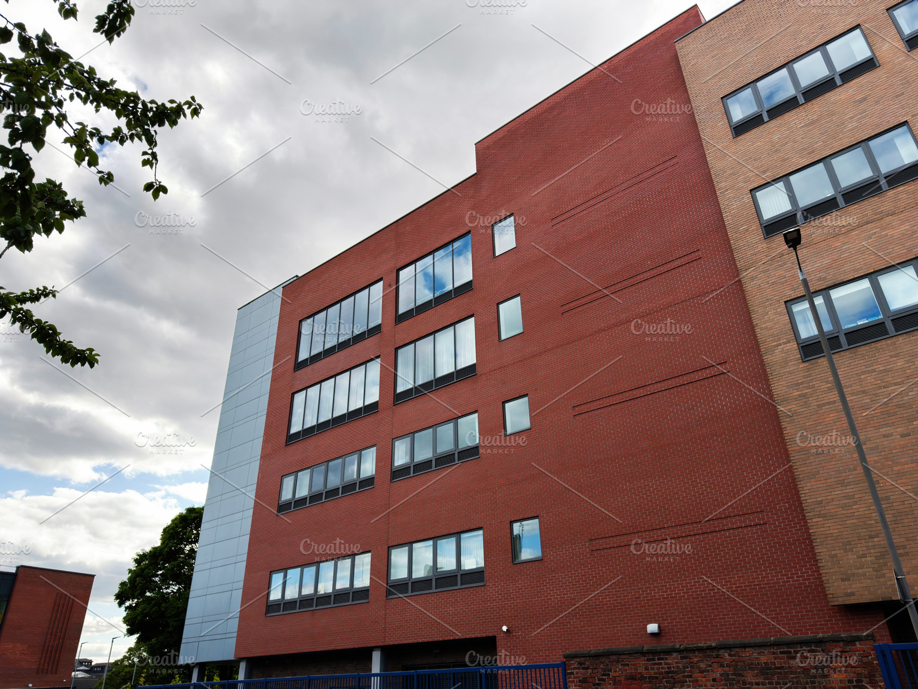 Modern brick office building with large windows in Manchester, U, a Photo by AS photostudio