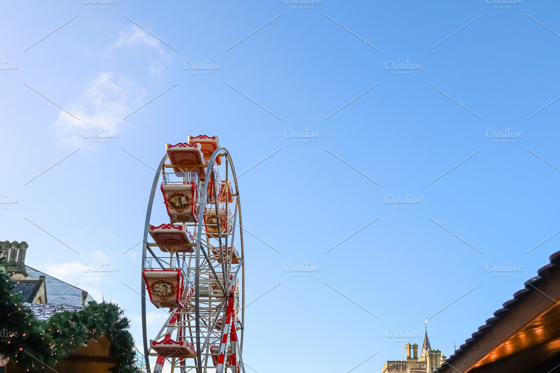 Ferris wheel turning at a Christmas market in Oxford, England, against a clear, a Photo by Studio ANNA
