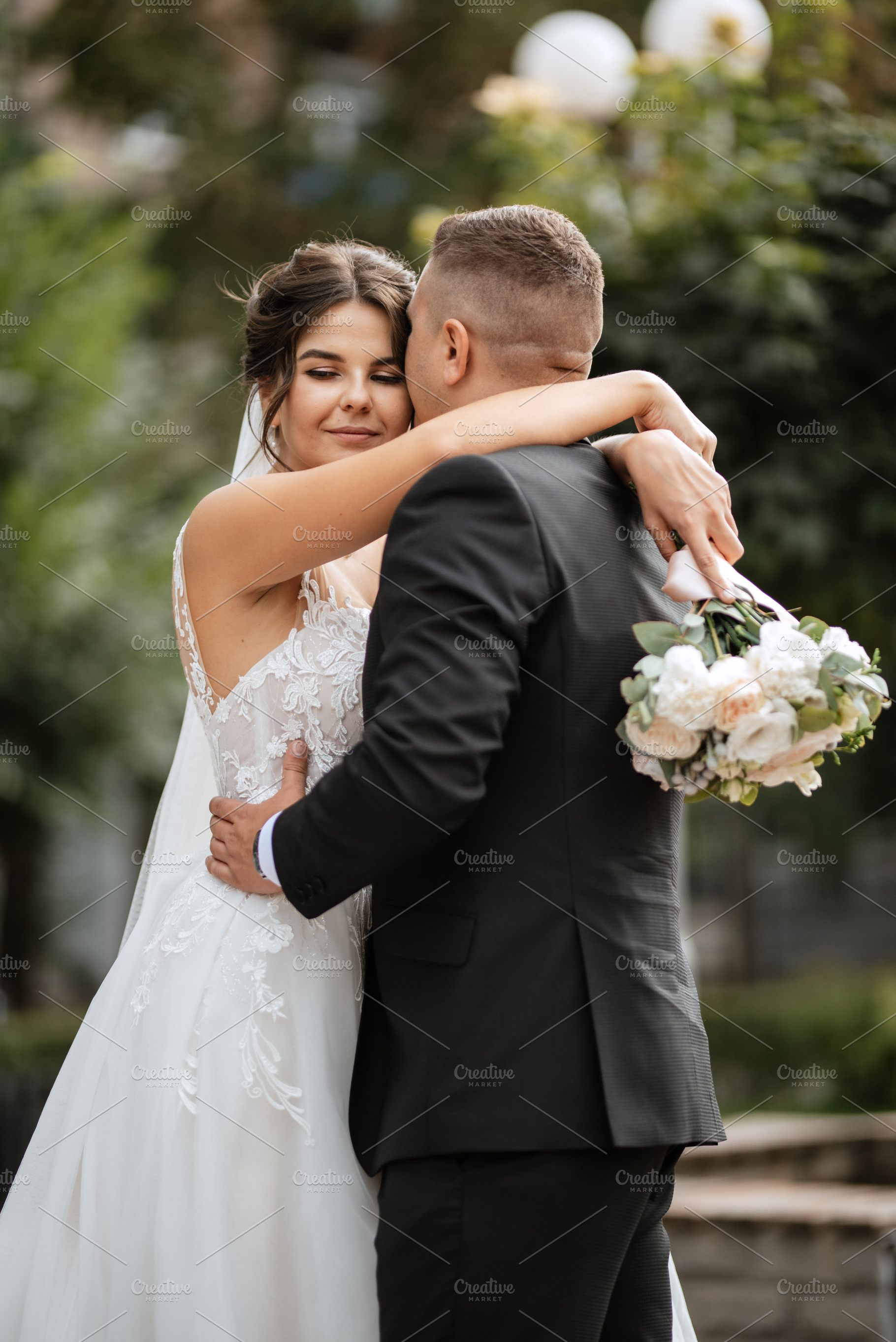 the groom in a brown suit and the bride in a white dress, a Person Photo by Weddings, People, Travel