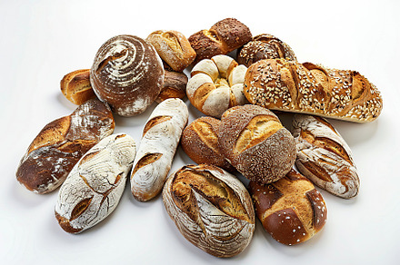 Freshly different baked bread isolated on white background, a Food & Drink Photo by AlyaAnd