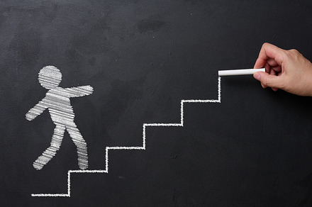 The chalk-drawn staircase goes up and the little man goes forwar, a Business Photo by ndanko