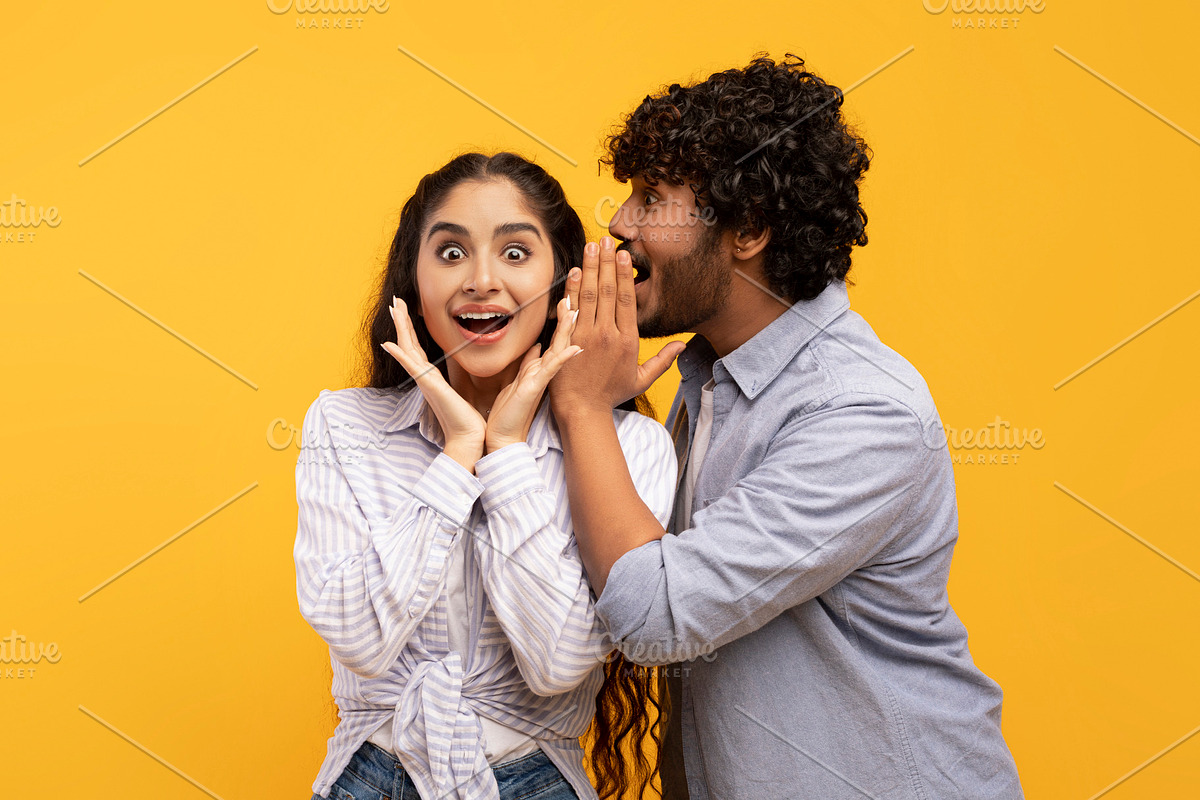 Shock, gossip, share advice. Young indian man whispering to lady on ear, surpri, a Photo by Prostock-Studio (Photo 4 of 4)