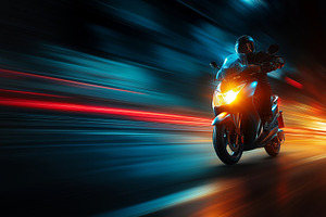 Dynamic Night Ride: Motorcyclist on Speeding Scooter with Blur Lighting Effects, a Transportation Photo by Ocean Digital Art