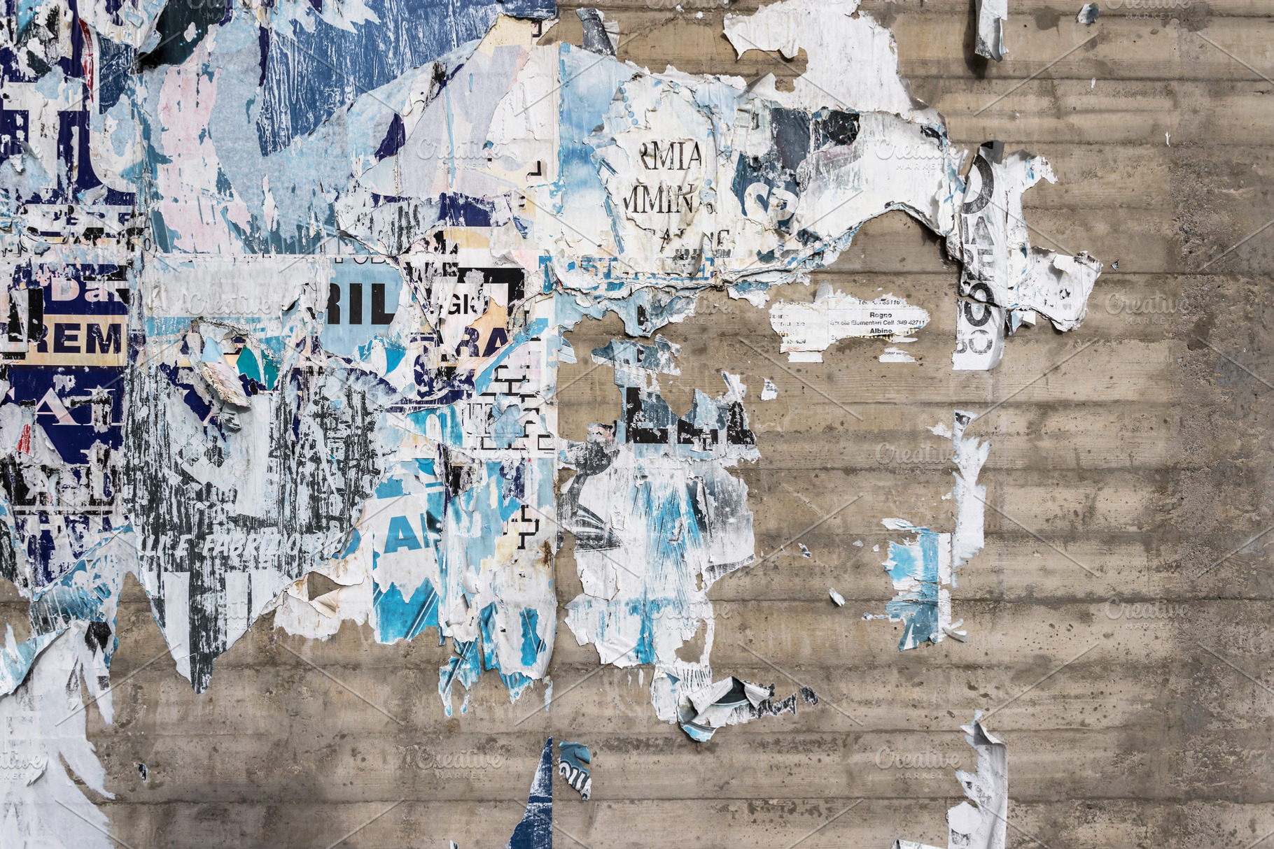 Wall with ripped posters, a Wallpaper Photo by KYNA STUDIO