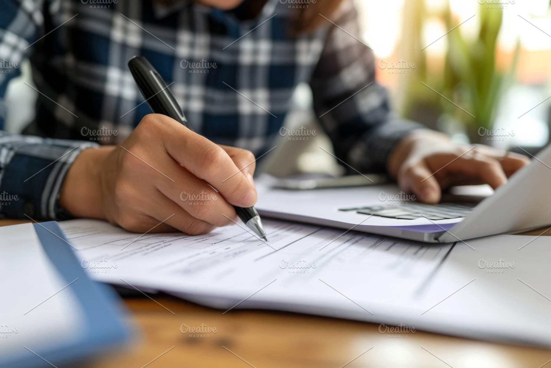 A person is seen using a pen to writ, a Photo by Iftikhar Alam