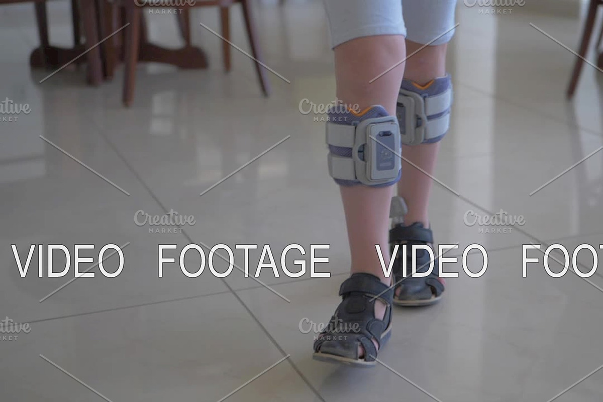 Therapy with functional electrical stimulation. Kid wearing foot drop system, a Graphic by Grey Coast Media (Photo 1 of 2)