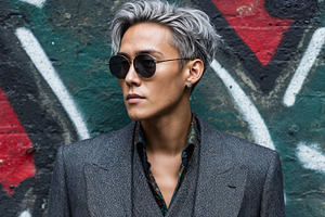 Influencer man flaunts fashion against colorful graffiti backdrop, a Person Photo by OSORIOartist