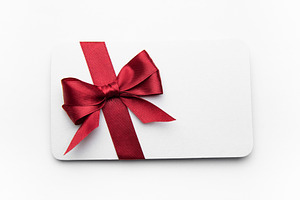Blank gift card decorated with red ribbon bow, a Holiday Photo by Olena Rudo
