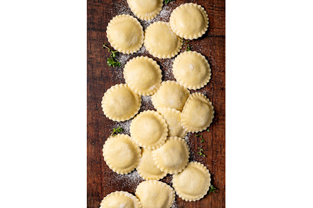 Fresh Ravioli Pasta on Wooden Board
