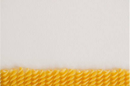 Spiral pasta on a white background, a Food & Drink Photo by olhovyi_photographer