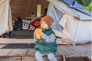 Young toddler tourist in a warm vest, a Person Photo by Elizaveta Galitskaya