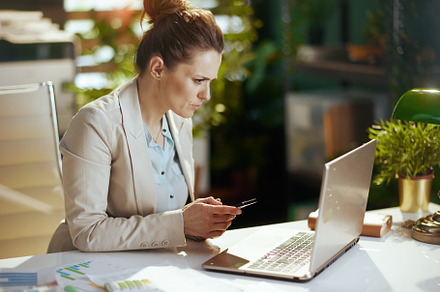 accountant woman in light business suit in green office, a Person Photo by Alliance Images