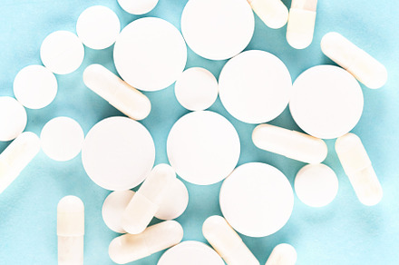 many different white pills on blue background. Assorted pharmace, a Health & Medical Photo by vimart
