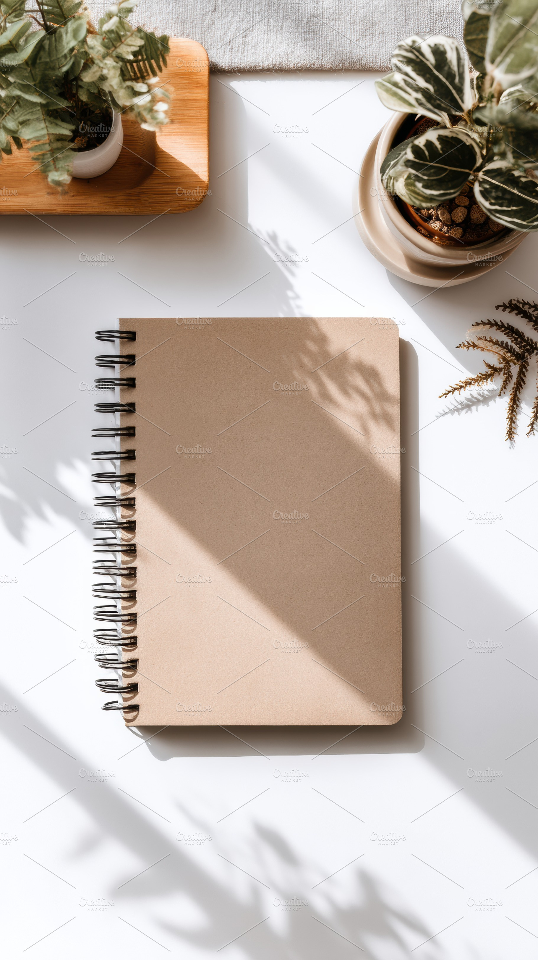 Single brown notebook on white, a Photo by Virgo Studio