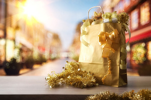 Christmas shopping concept with gift bag on street with shops, a Holiday Photo by Davizro's Market