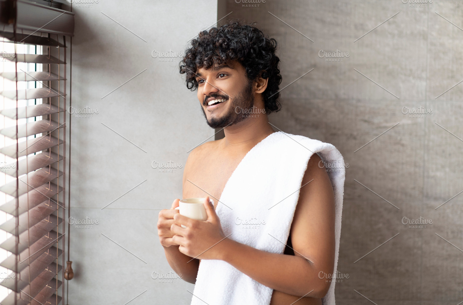 Happy indian man enjoying morning in bathroom, standing next to huge panoramic, a Person Photo by Prostock-Studio