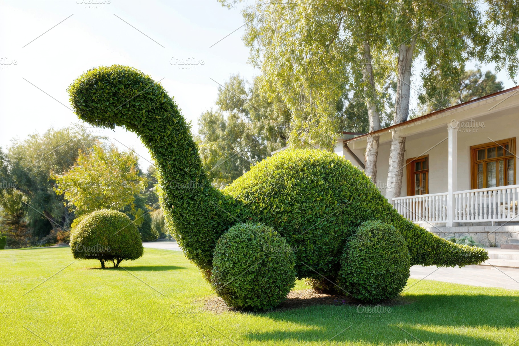 Topiary sculpture of a dinosaur made from green bushes, a Nature Photo by AlyaAnd