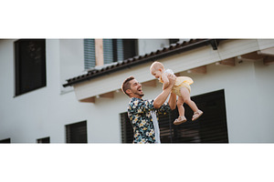 Happy father playing with his baby, a Person Photo by HalfPoint