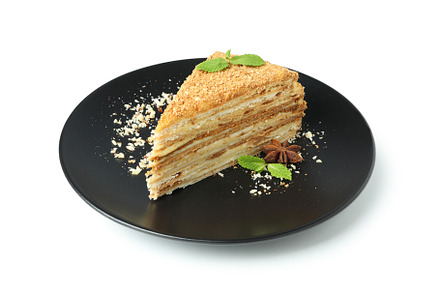 Plate with piece of honey cake isolated on white background, a Food & Drink Photo by AtlasStudio PRO