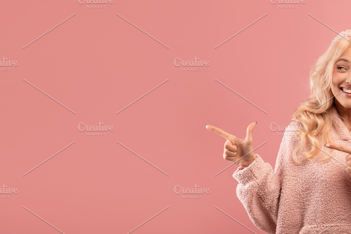 Excited young lady pointing and looking aside at empty space, demonstrating pla, a Photo by Prostock-Studio (Photo 2 of 2)