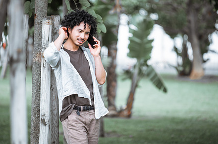 Man talking on phone in green park, a Person Photo by SkyNext