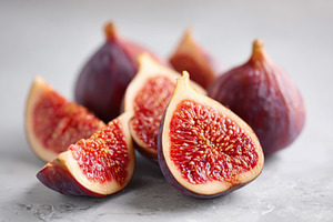 Fresh figs on grey background, a Food & Drink Photo by AlyaAnd