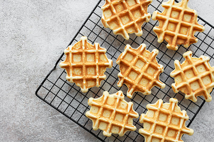 Freshly baked waffles on a baking rack., a Food & Drink Photo by Olena Rudo