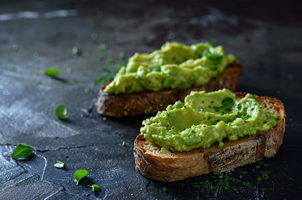 Toast breads with avocado puree on grey background. Vegetarian food., a Food & Drink Photo by AlyaAnd