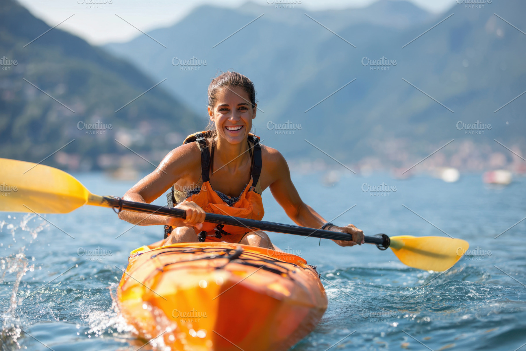 Young woman kayaking on a scenic lake, a Sports & Recreation Photo by AlyaAnd