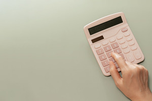 Hand using calculator on pastel background. Concept of personal, a Photo by salmon.black