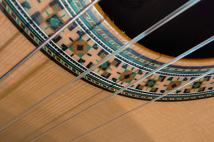 Close-up, high-angle detail shot of a classic spanish guitar, an Arts & Entertainment Photo by DanFLCreativo