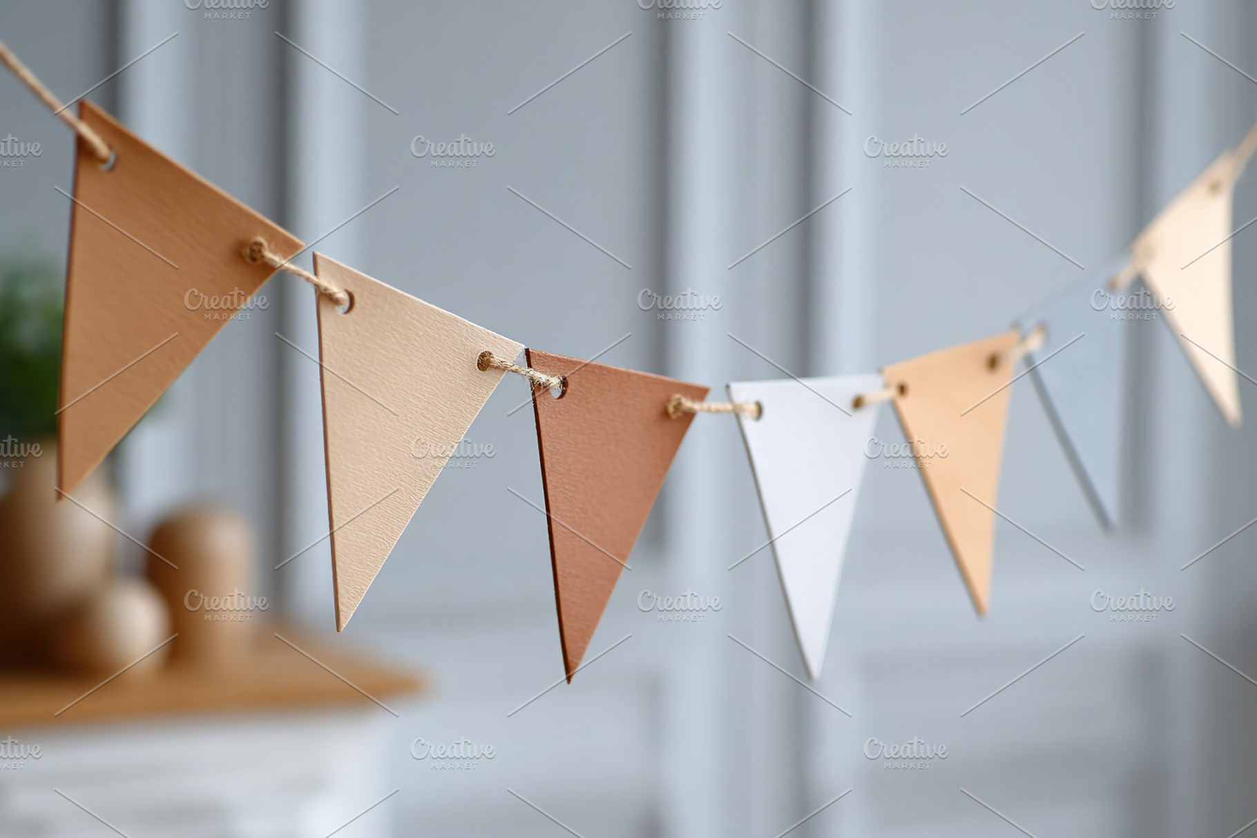 Delicate arrangement of minimalist paper bunting flags hanging indoors in a mod, a Background Photo by AlyaAnd